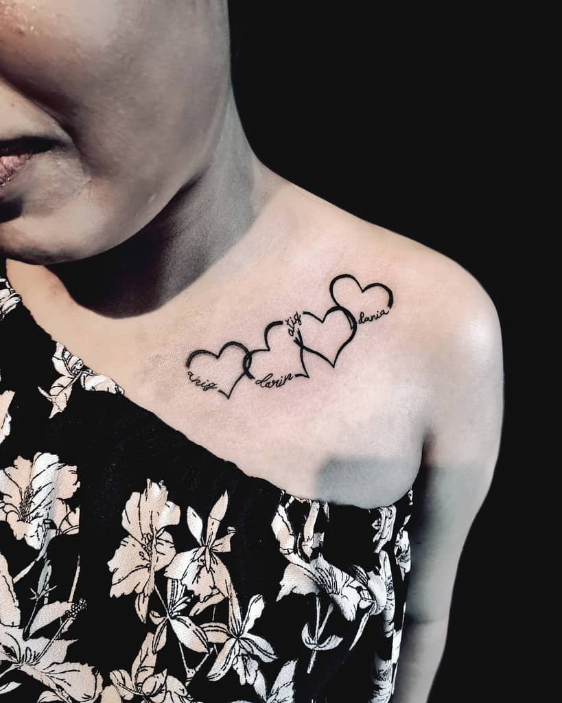Woman with heart-outline tattoos and names on collarbone