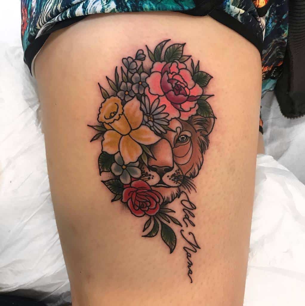 A striking tattoo of a lion intertwined with delicate flowers graces the thigh, accompanied by the poignant text "Old Name"