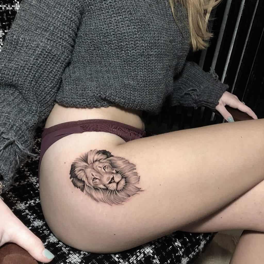 A woman with a small lion tattoo gracing her thigh