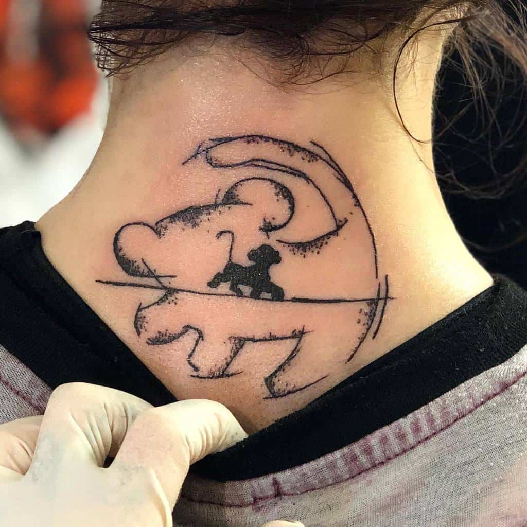 A minimalist tattoo depicting a silhouette of Simba, with a cloud-like design and the iconic line from The Lion King, on the back