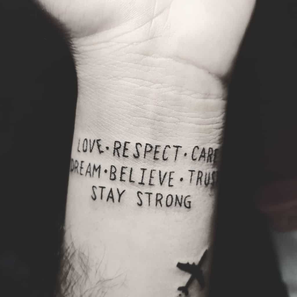 Wrist tattoo with motivational words: Love, Respect, Care, Dream, Believe, Trust, and Stay Strong in bold black text