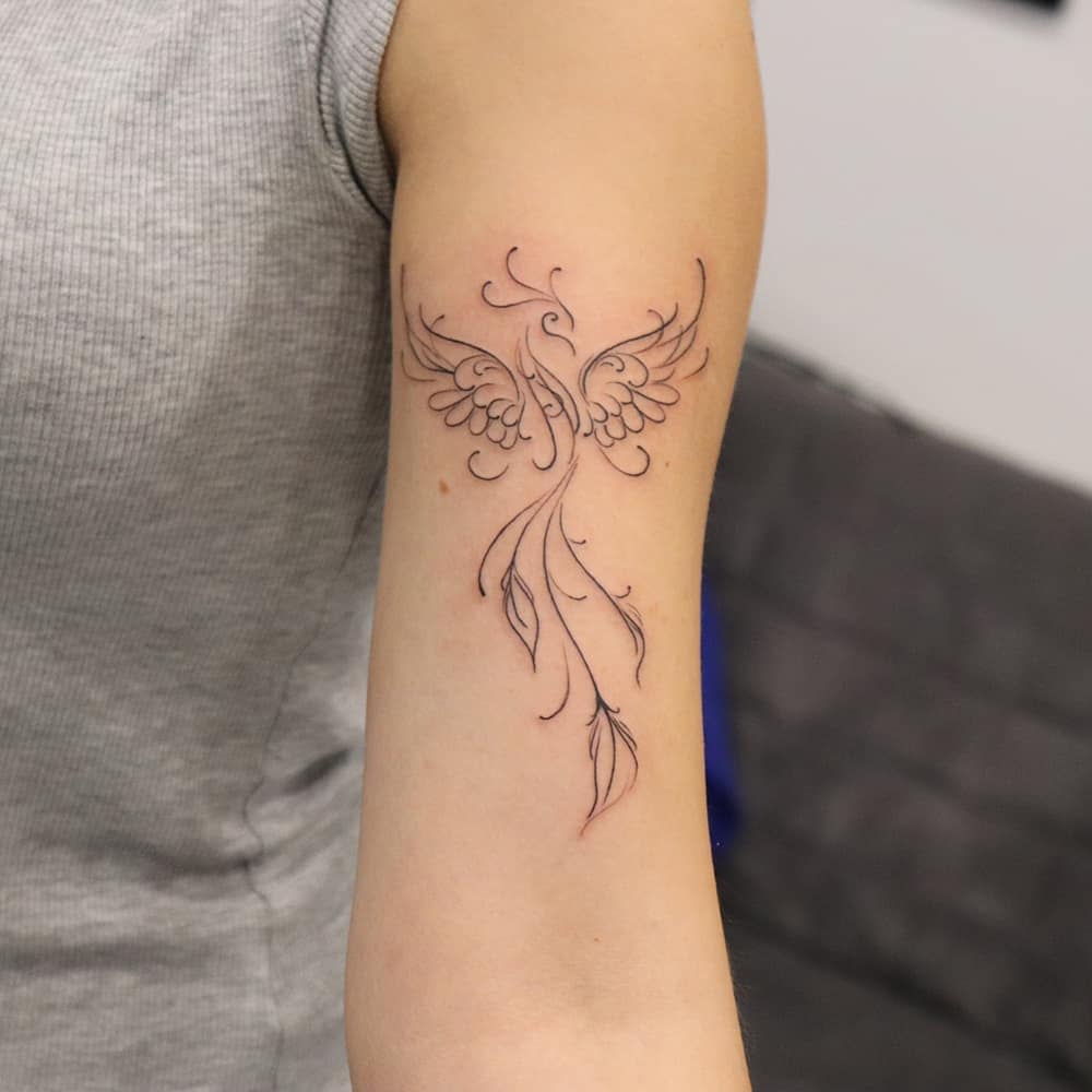 Simple phoenix tattoo on inner upper arm