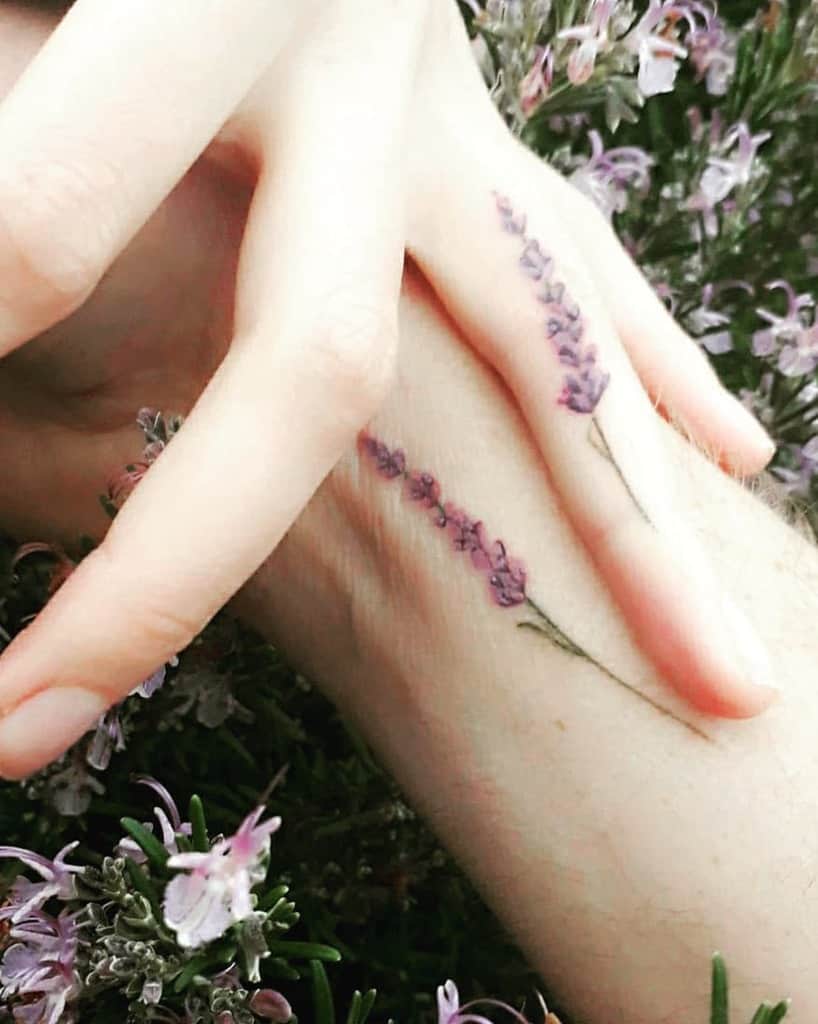 Hand with a delicate lavender tattoo on the wrist