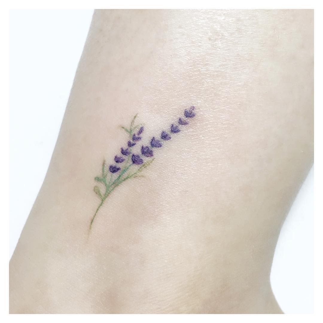 A small tattoo of a lavender sprig with green leaves