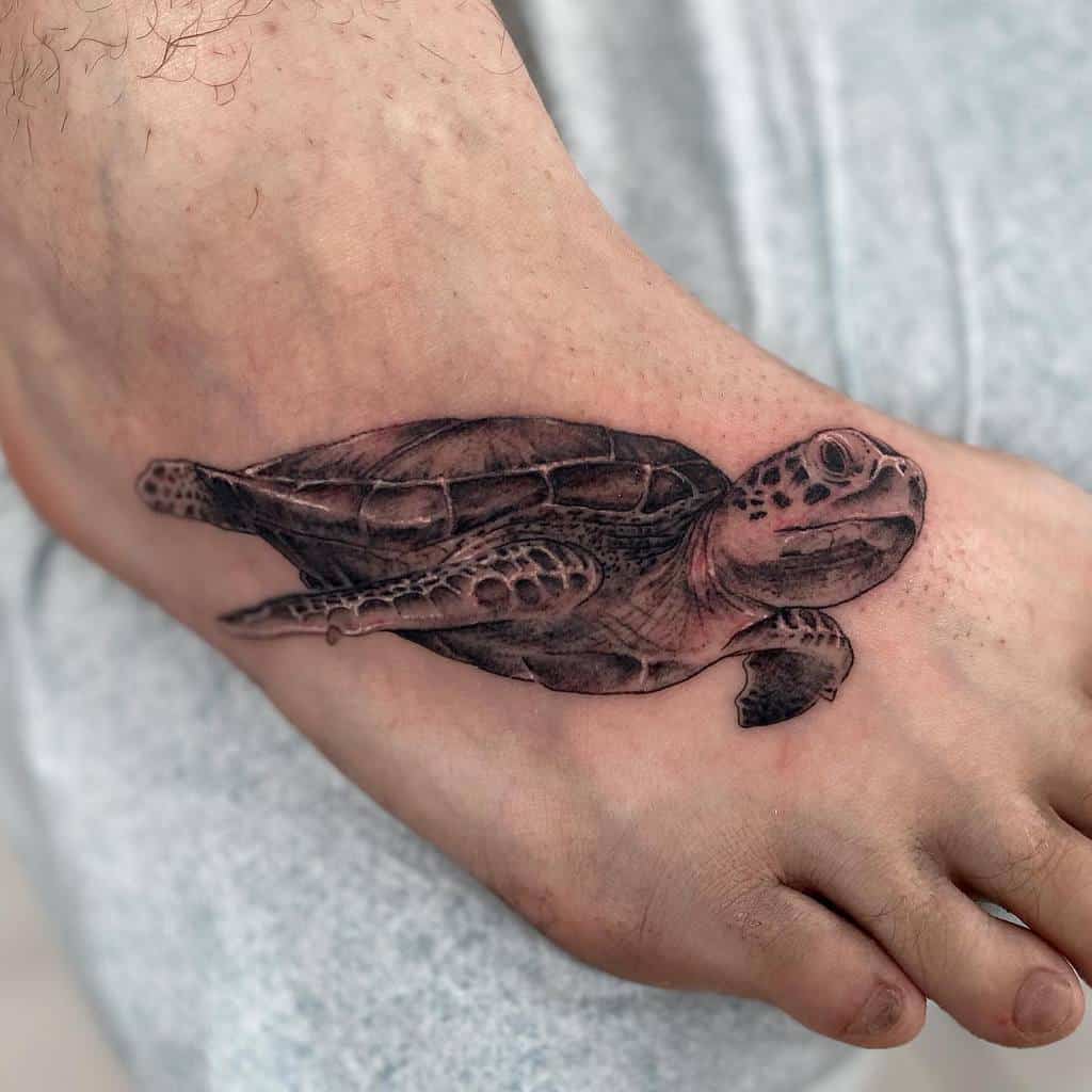 Realistic sea turtle tattoo on foot, showcasing detailed shading and texture