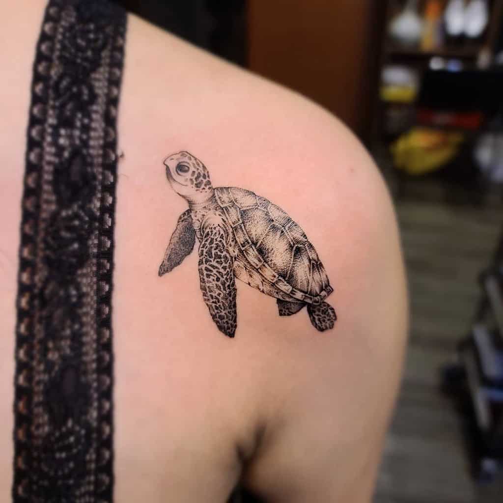 Small sea turtle tattoo on a shoulder