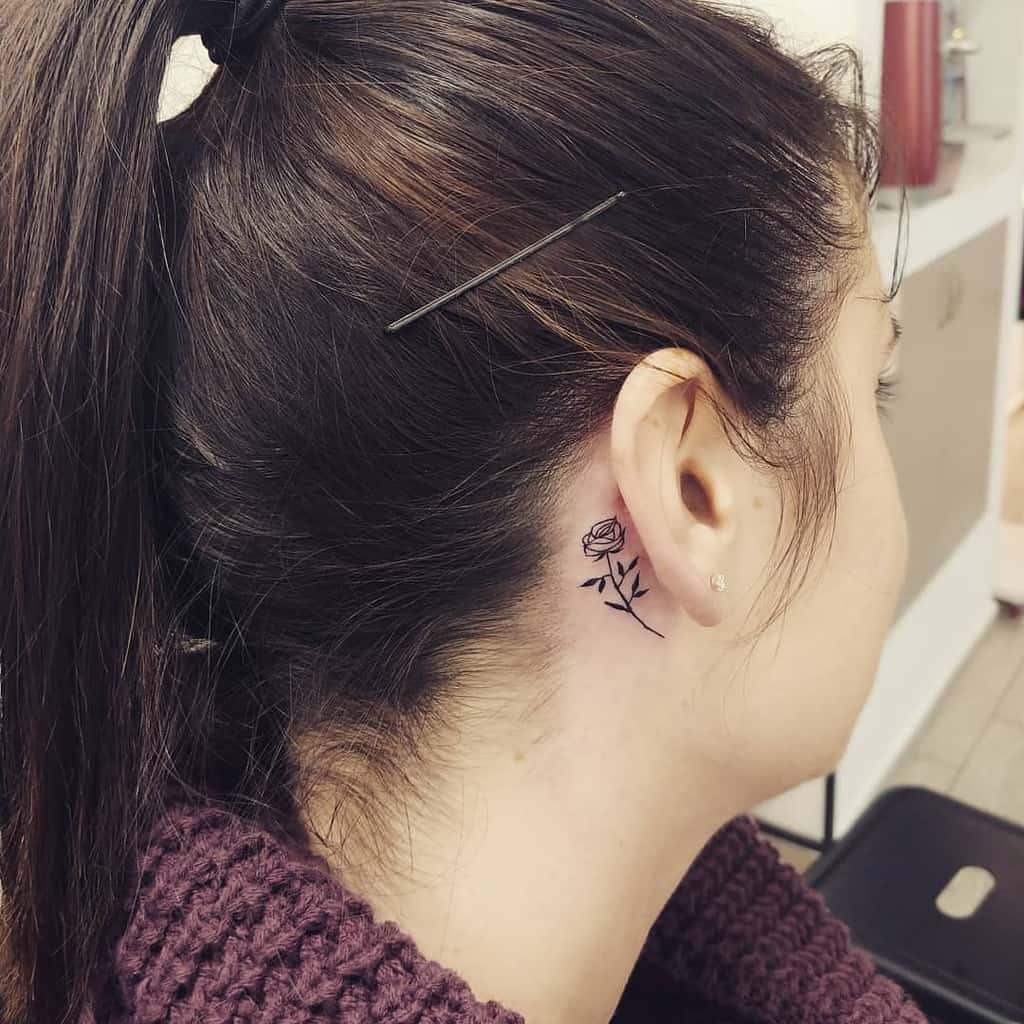 Woman with rose tattoo behind her ear