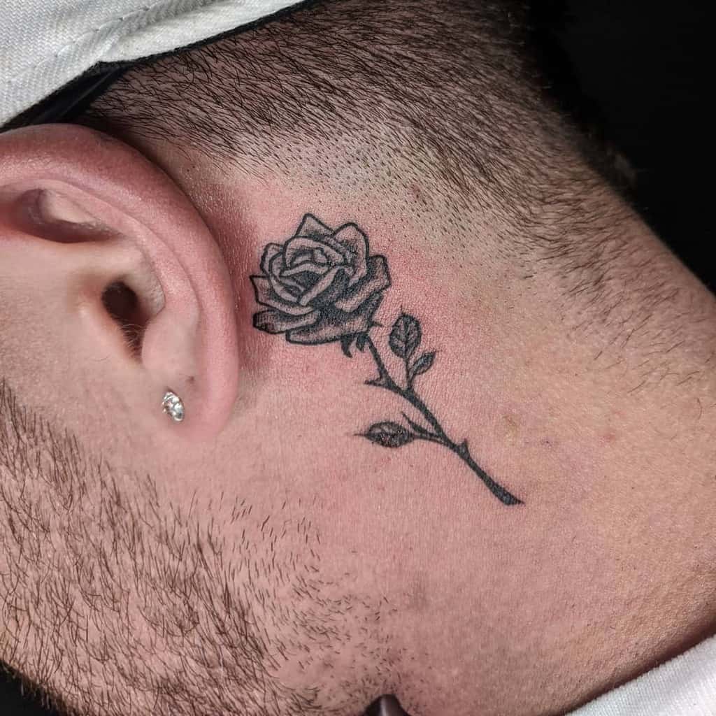 Close-up of a rose tattoo on a man's neck