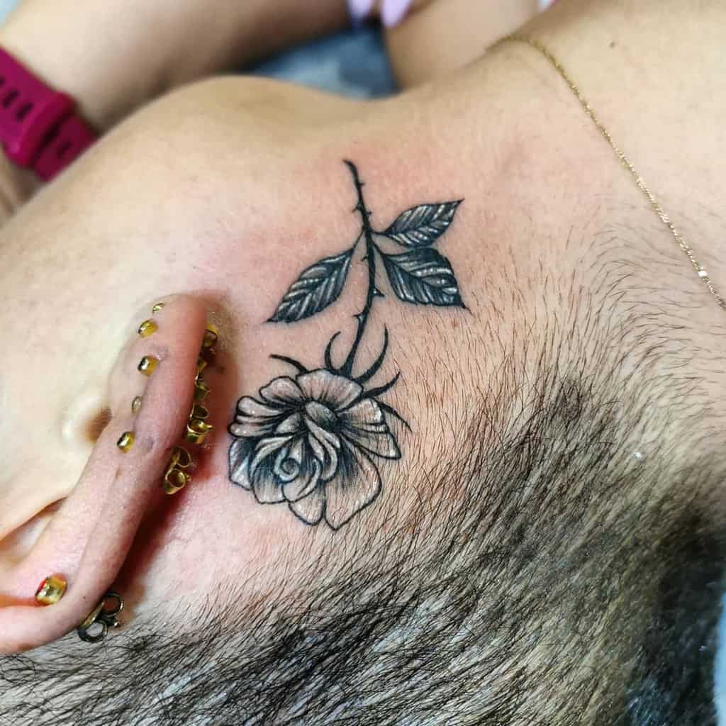 A person with a rose tattoo on their neck