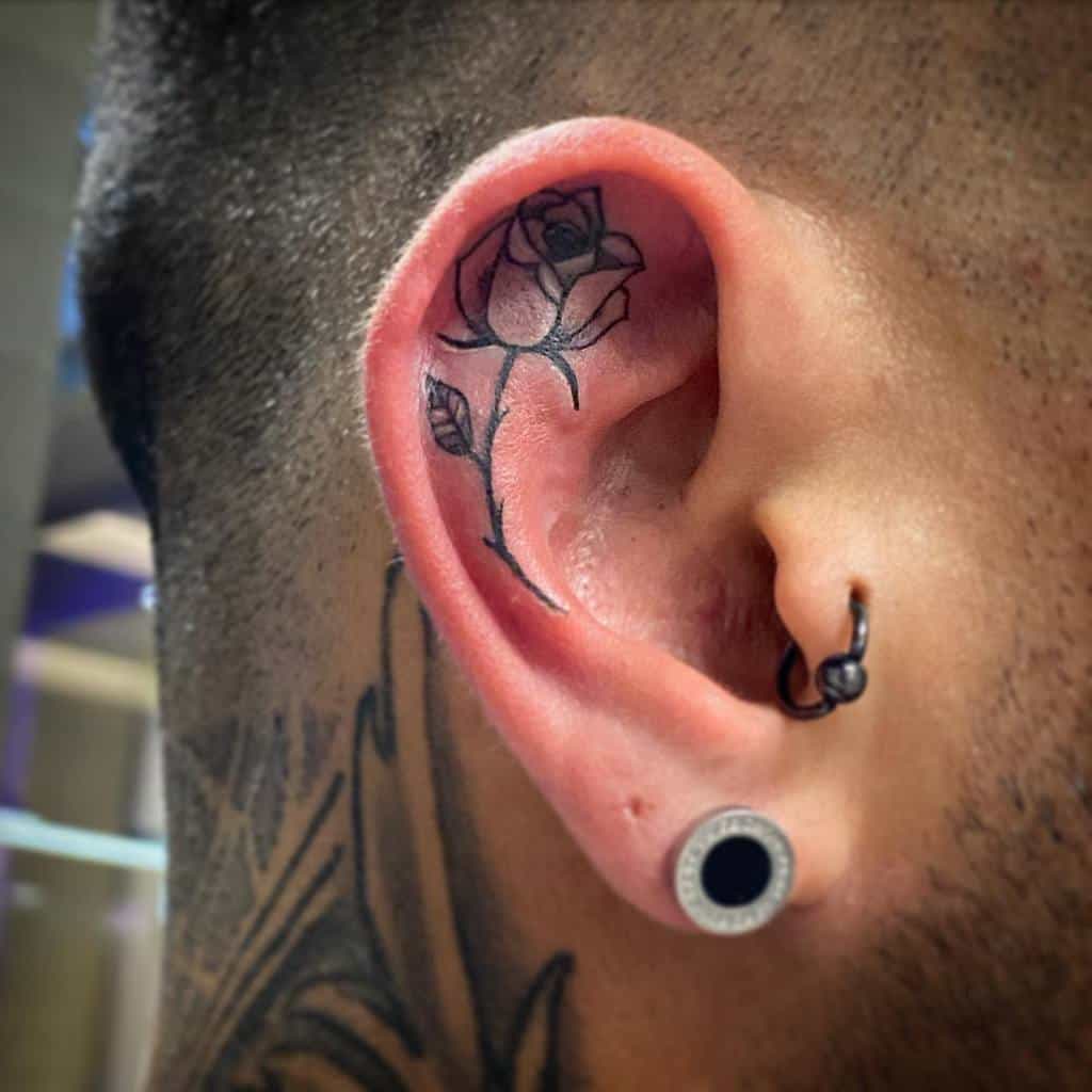 Ear tattooed with a rose design