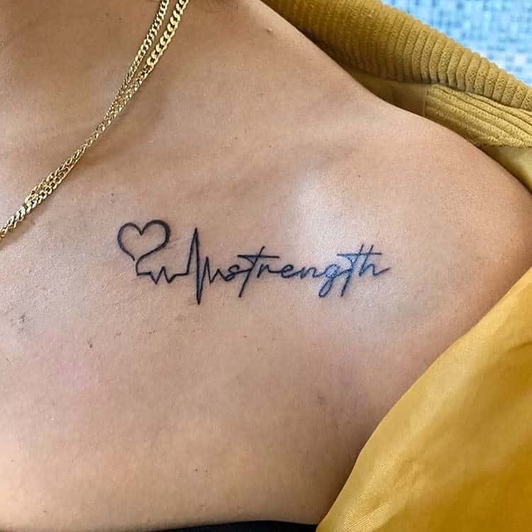 A tattoo of a heartbeat line forming a heart and the word "strength" on a woman's chest