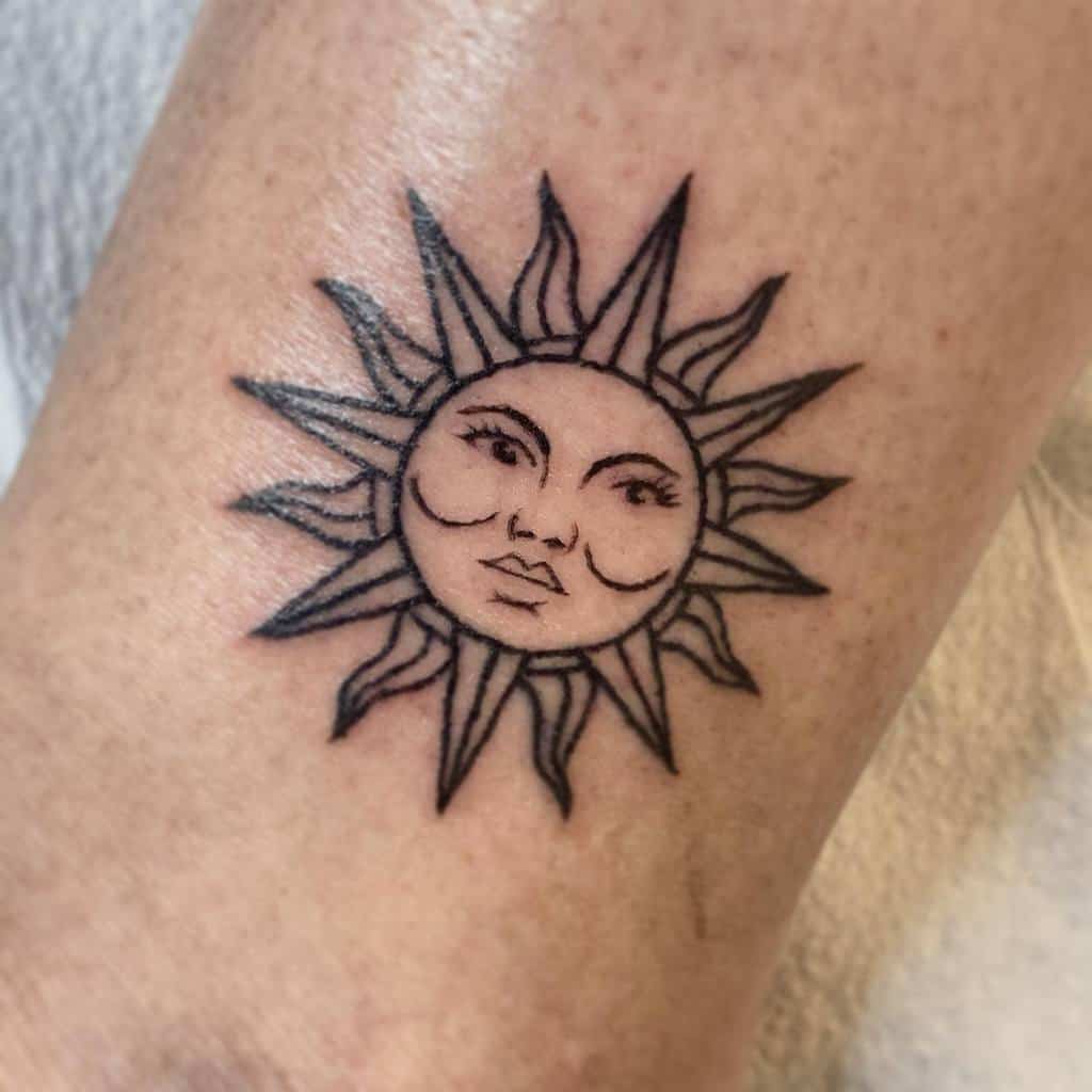 A tattoo of a sun with a smiling face, featuring wavy rays