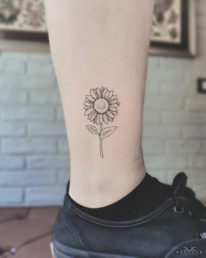 Line art sunflower tattoo on an ankle