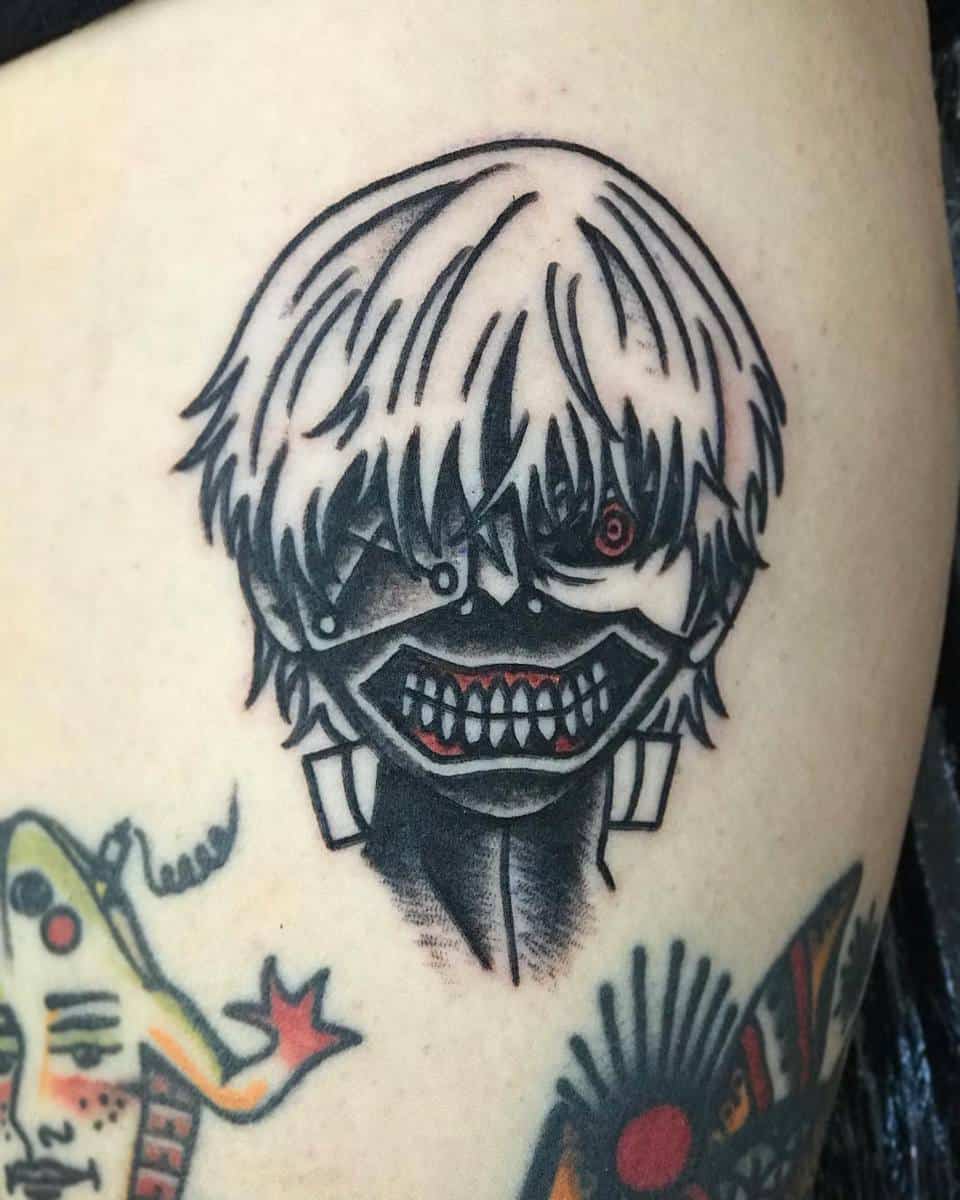 Small tattoo of Kaneki Ken from Tokyo Ghoul, featuring his ghoul mask and red eye detail
