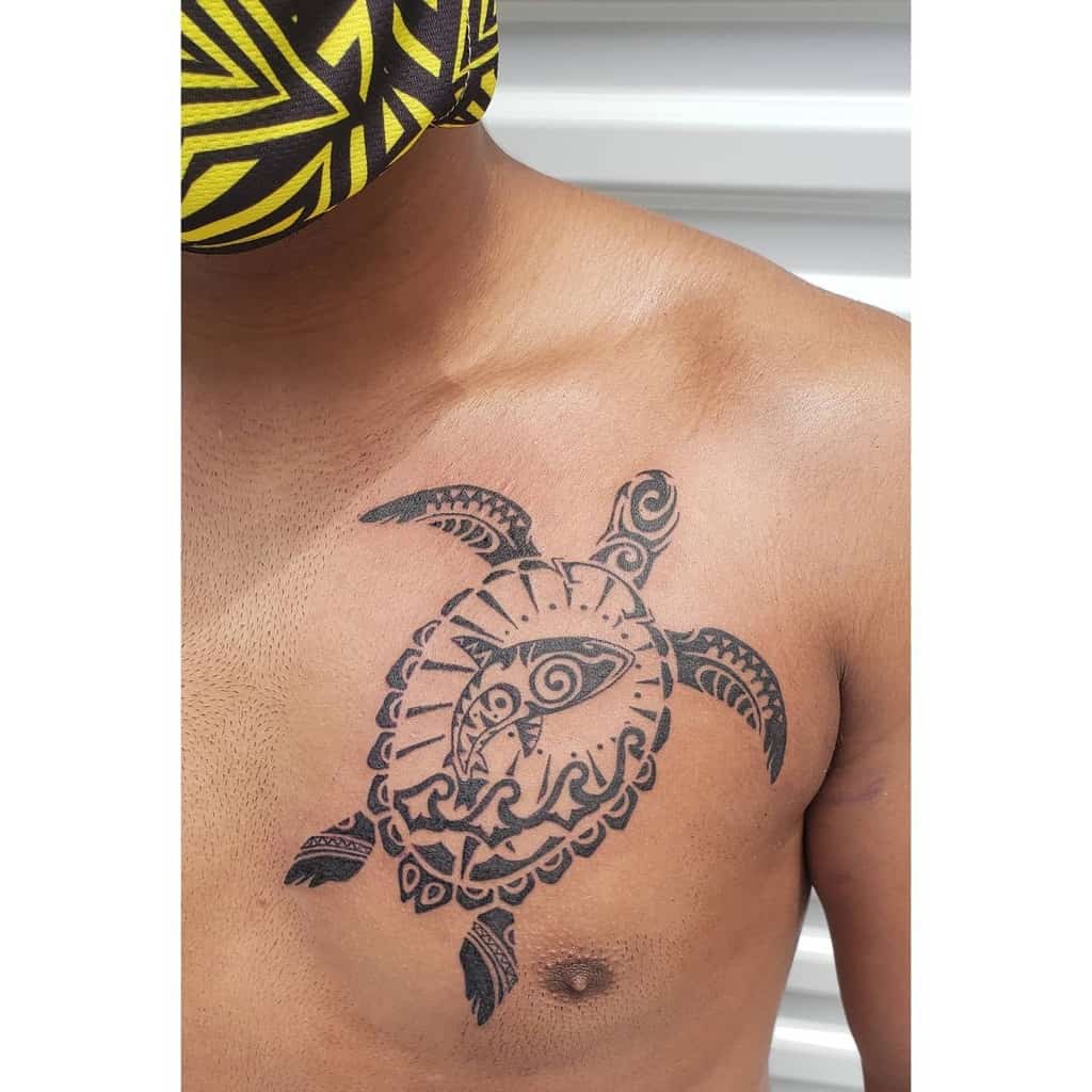 Chest tattoo featuring a stunning tribal turtle design, seamlessly blending traditional artistry with modern flair