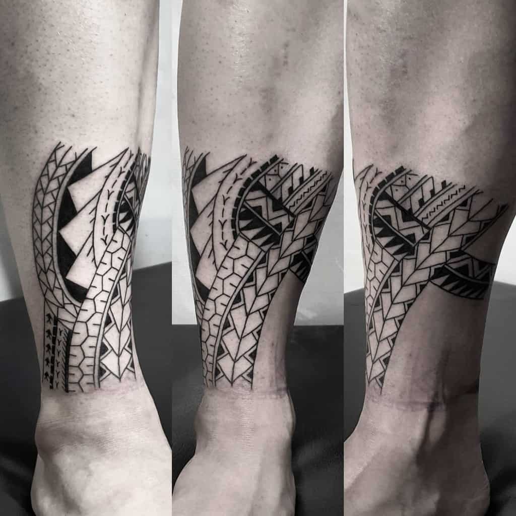Leg adorned with a small black tattoo that seamlessly blends tribal patterns with bold geometric and abstract shapes