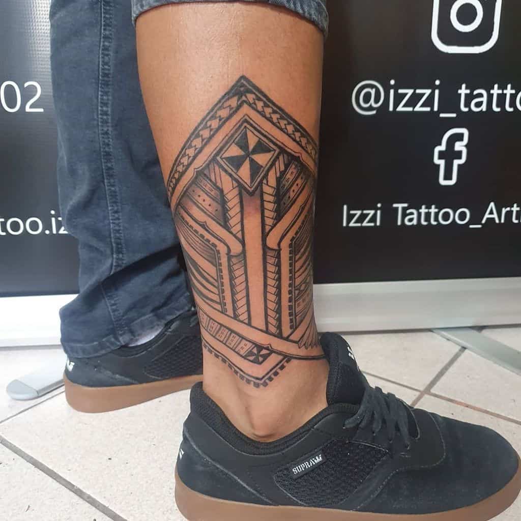 A stunning geometric leg tattoo featuring intricate tribal patterns adorns a person's calf