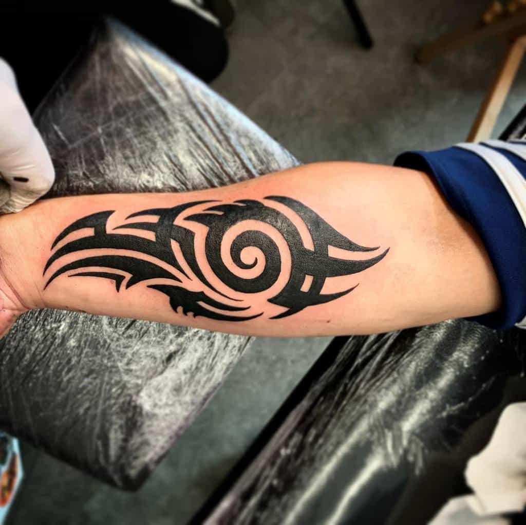 Intricate tribal design tattooed on a forearm