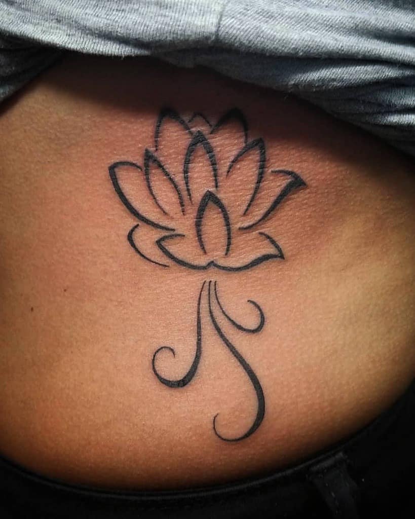 Lotus flower tattoo with swirl details in black ink