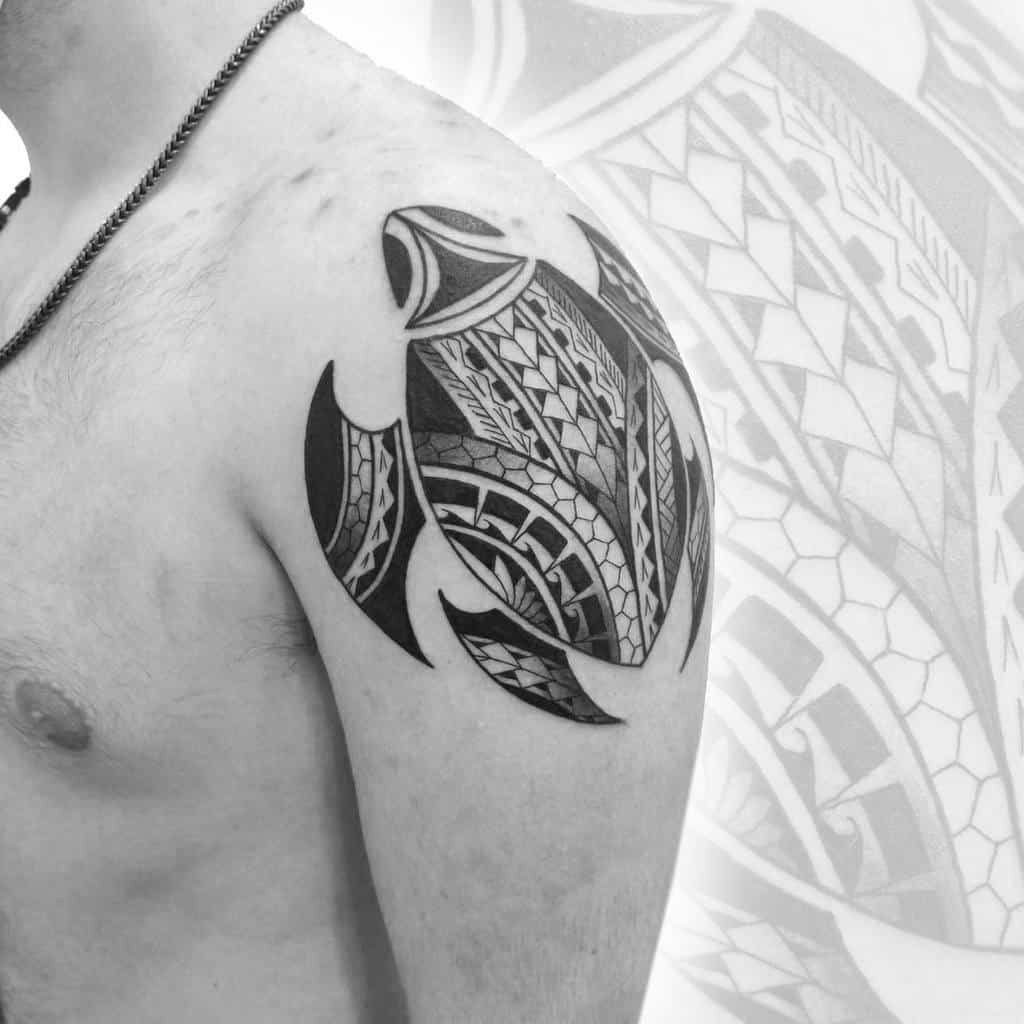 Turtle tattoo with tribal patterns on a man's shoulder
