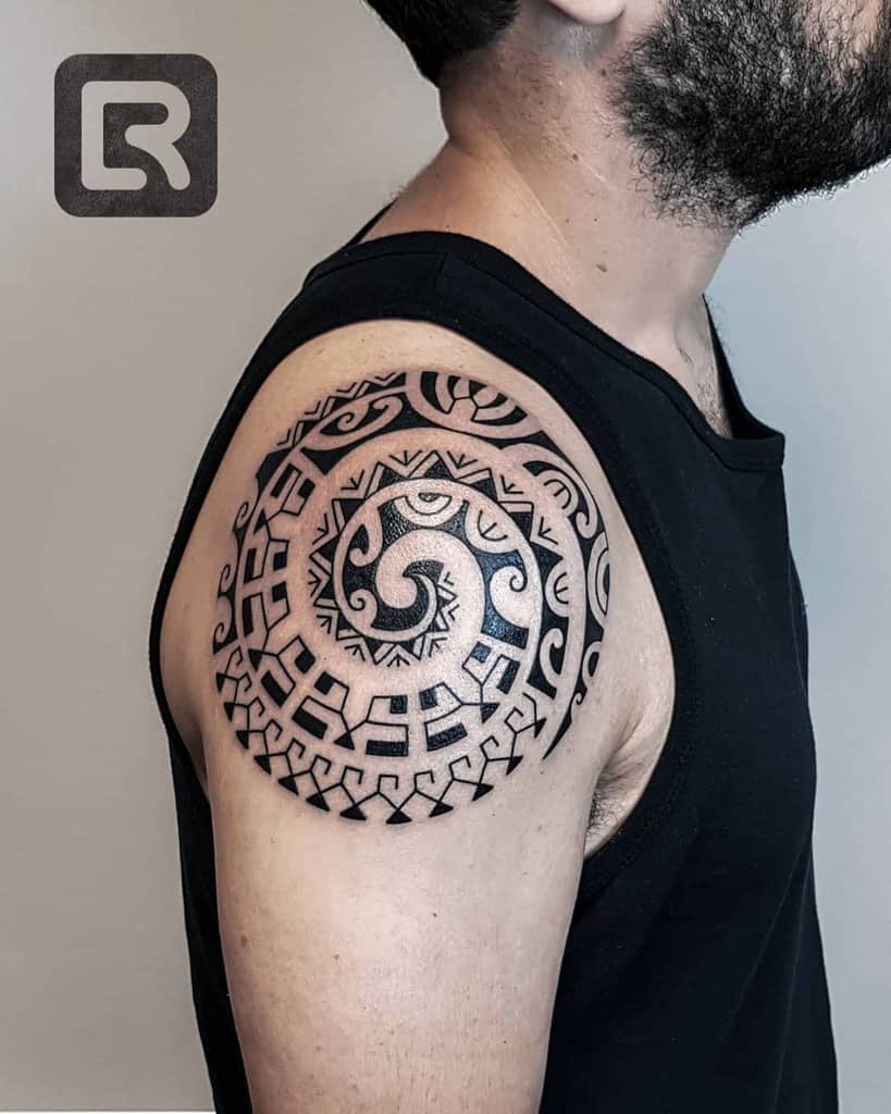 Man with a tribal spiral tattoo on his upper arm