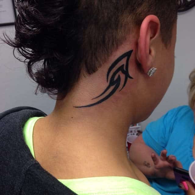 Woman with a black tribal tattoo on her neck