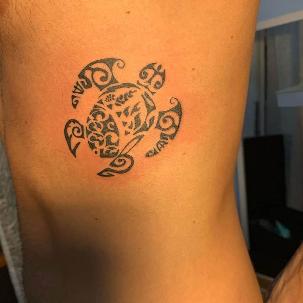 Ornate turtle tattoo featuring intricate tribal patterns