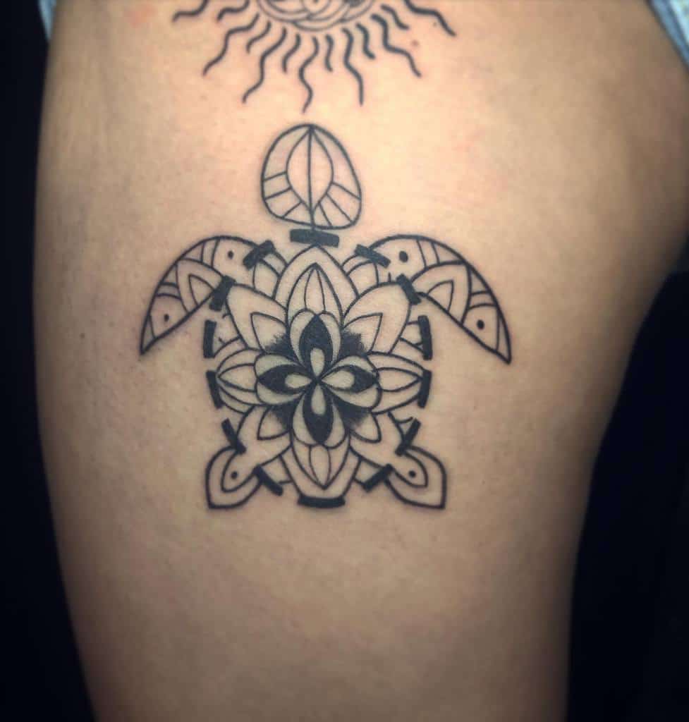 Turtle tattoo with intricate geometric patterns on skin