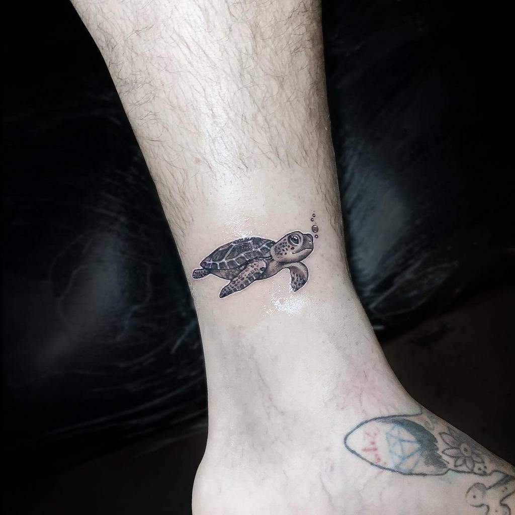 A small sea turtle tattoo on an ankle