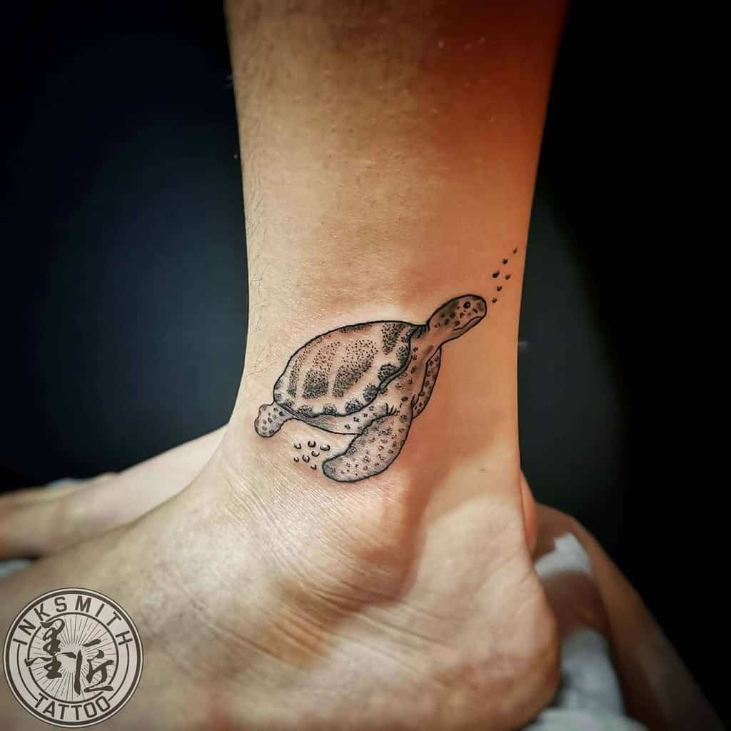 Turtle tattoo on an ankle, with shaded details and small dots