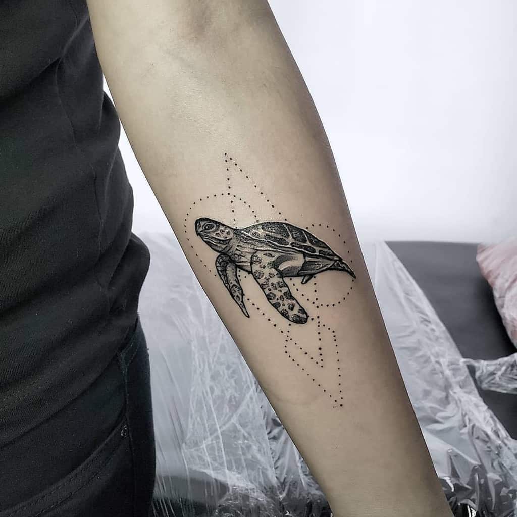 Turtle tattoo with geometric design on a forearm