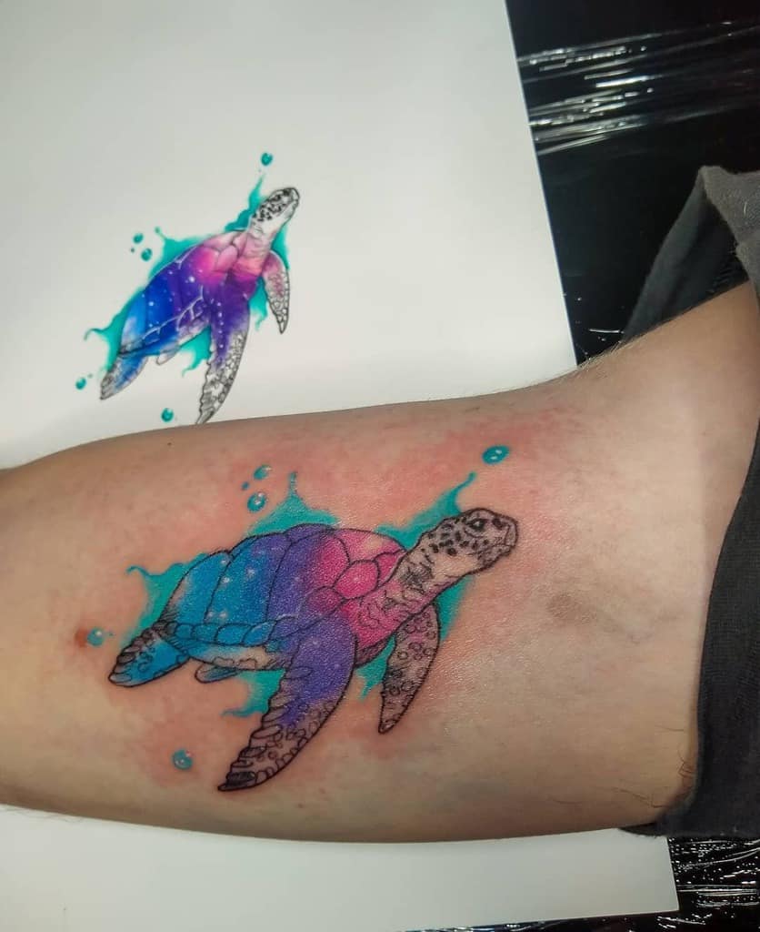 Colorful sea turtle tattoo with matching sketch on paper
