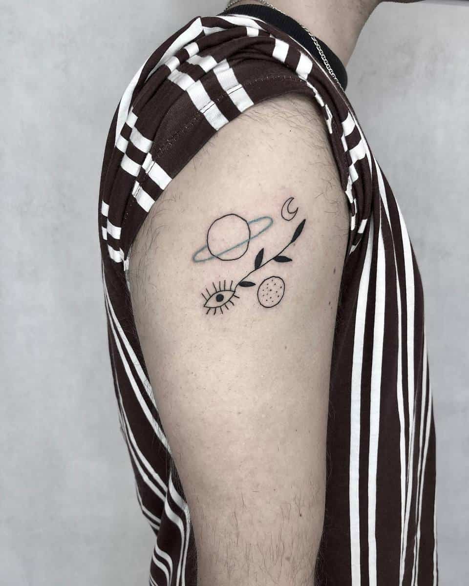 Tattoo of space-themed symbols on an upper arm