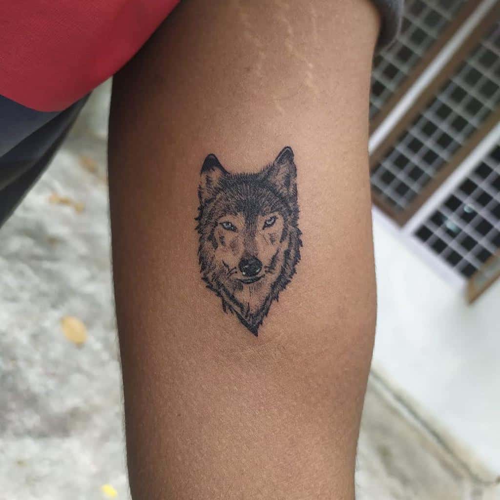 Tattoo of a majestic wolf's head gracing a person's arm