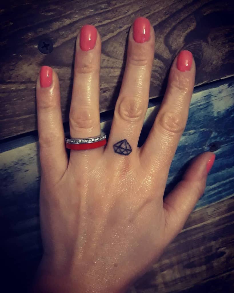 Hand with a geometric diamond tattoo on the middle finger