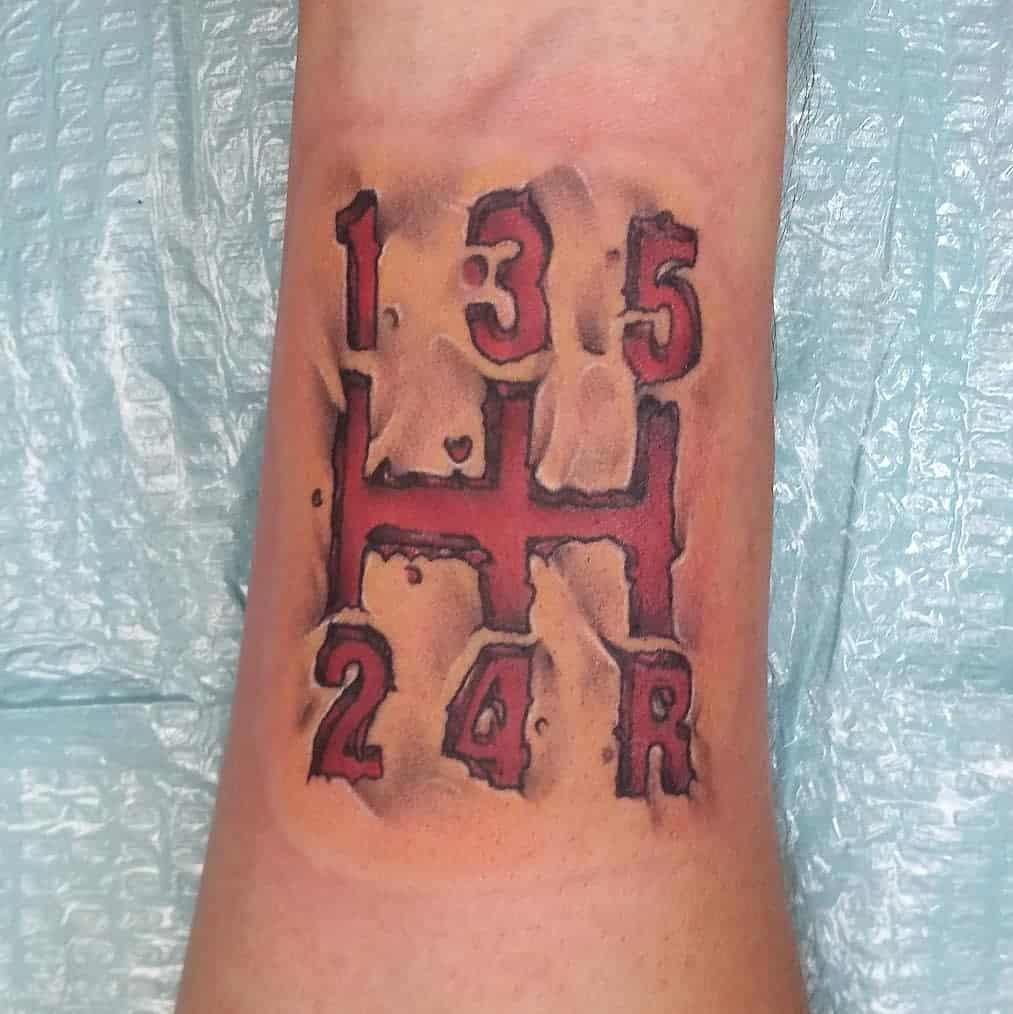 A tattoo resembling a 5-speed gear shift pattern on a wrist