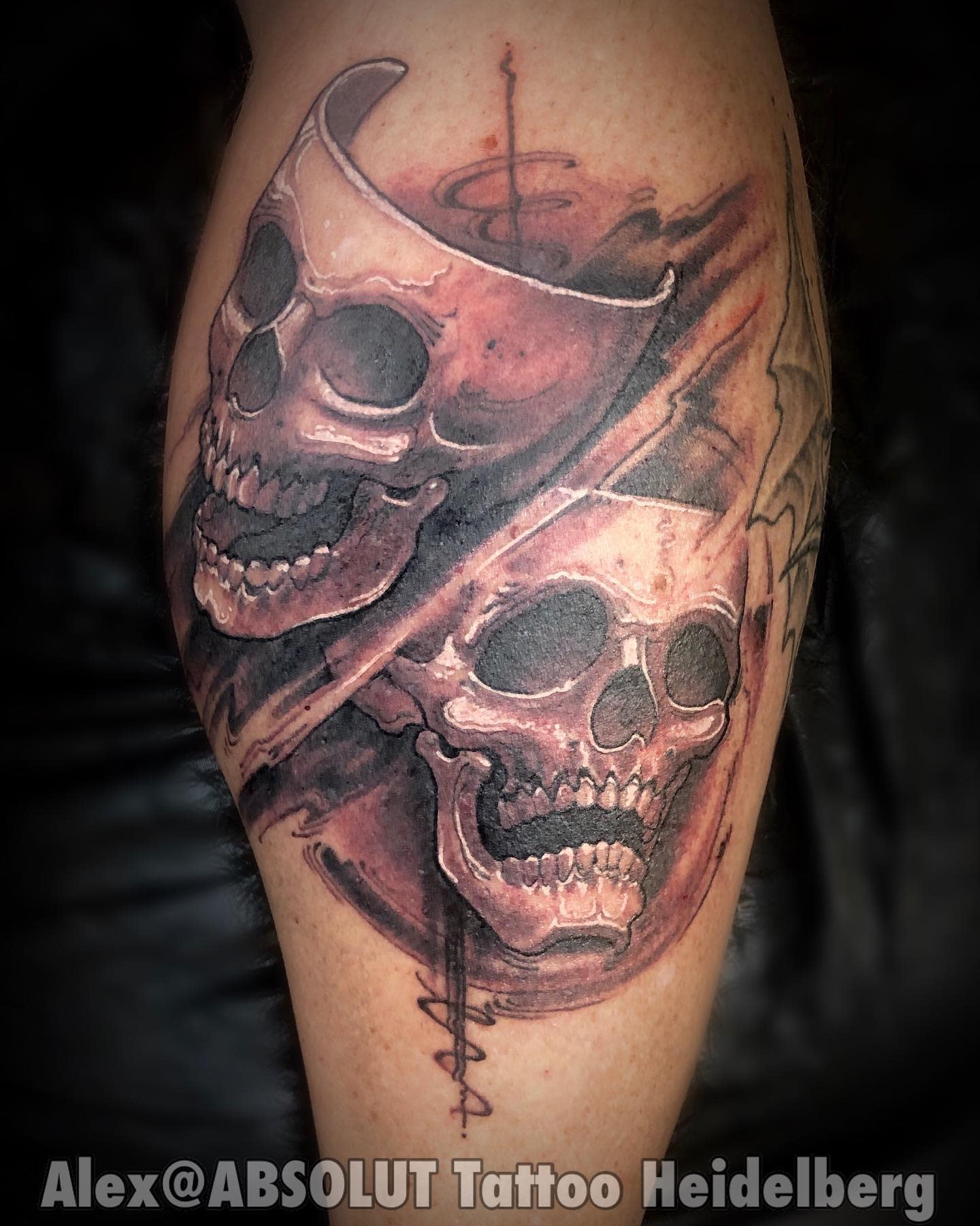 Tattoo featuring two grinning skulls overlapping