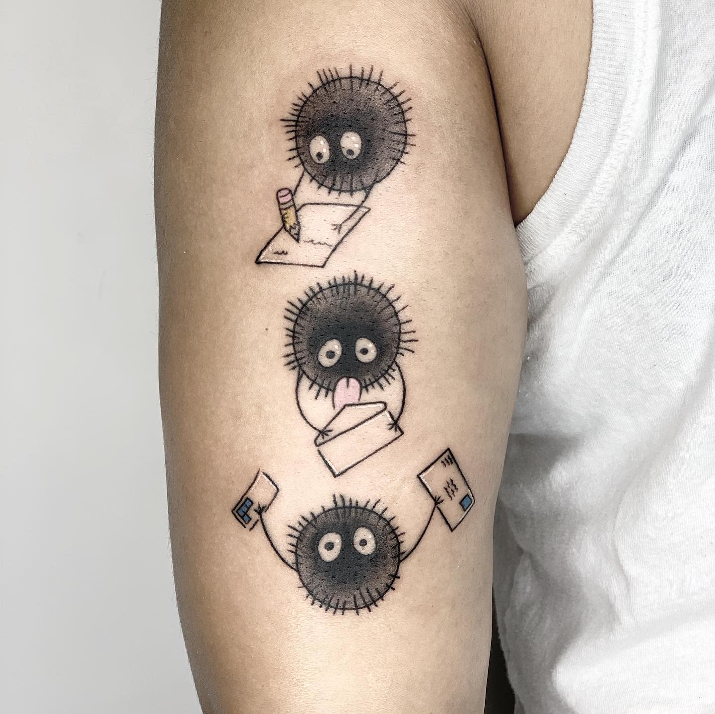 Tattoo of three soot sprites writing, licking an envelope, and mailing letter