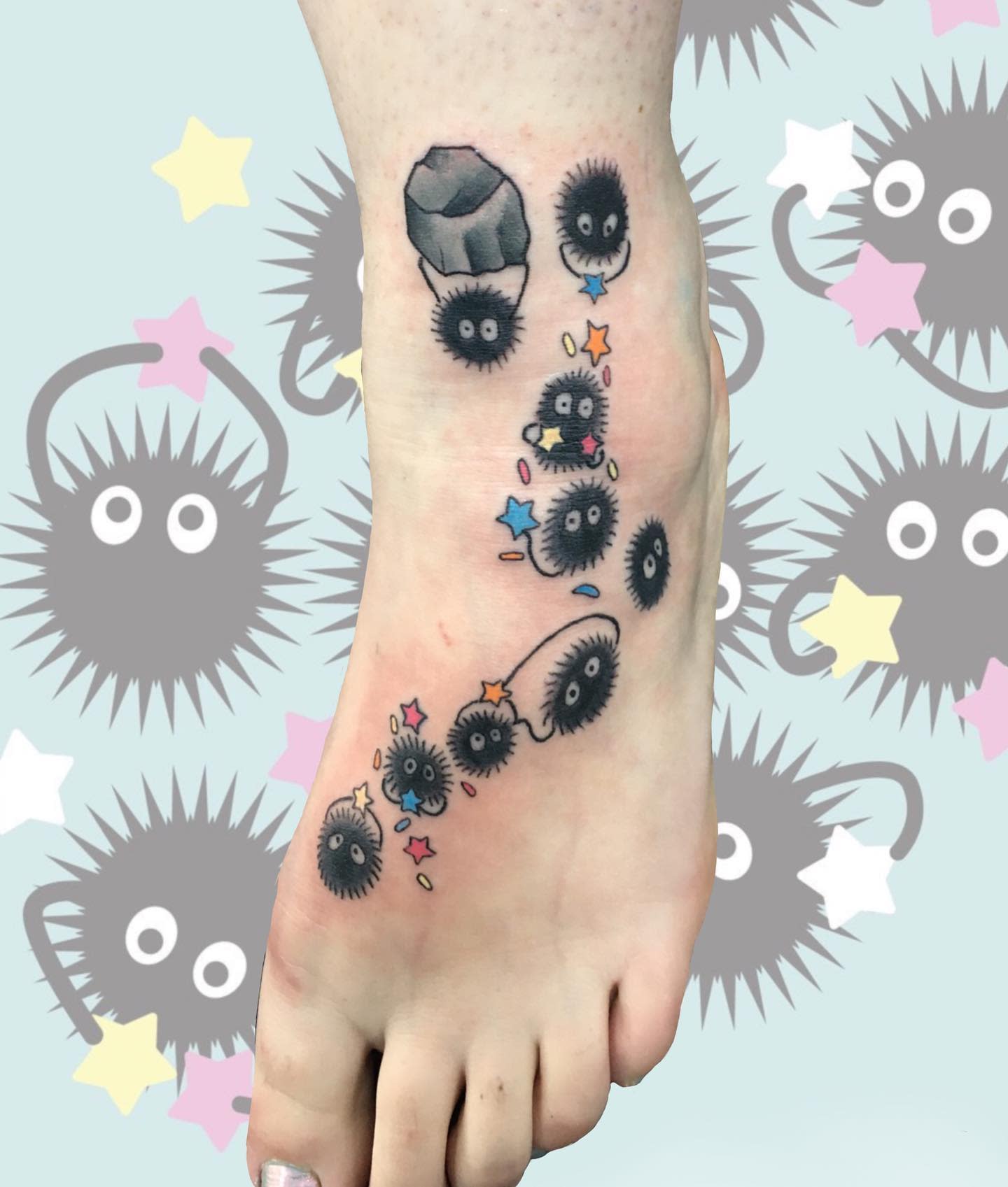 Tattoo of soot sprites on a foot