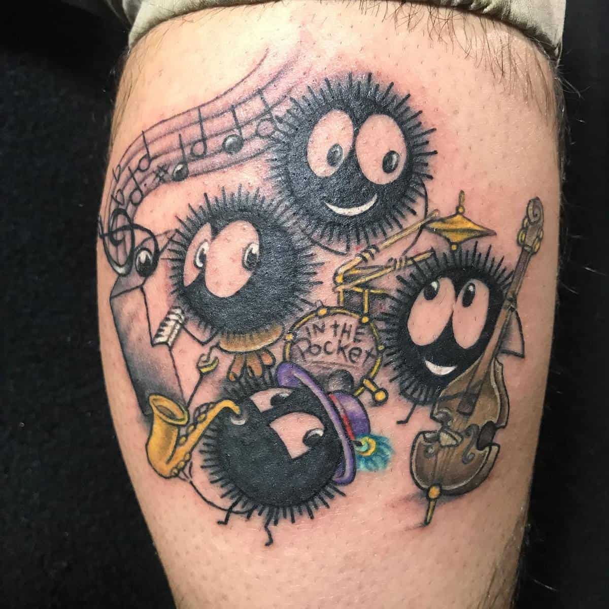 Playful tattoo of soot sprites from Studio Ghibli's Spirited Away playing musical instruments