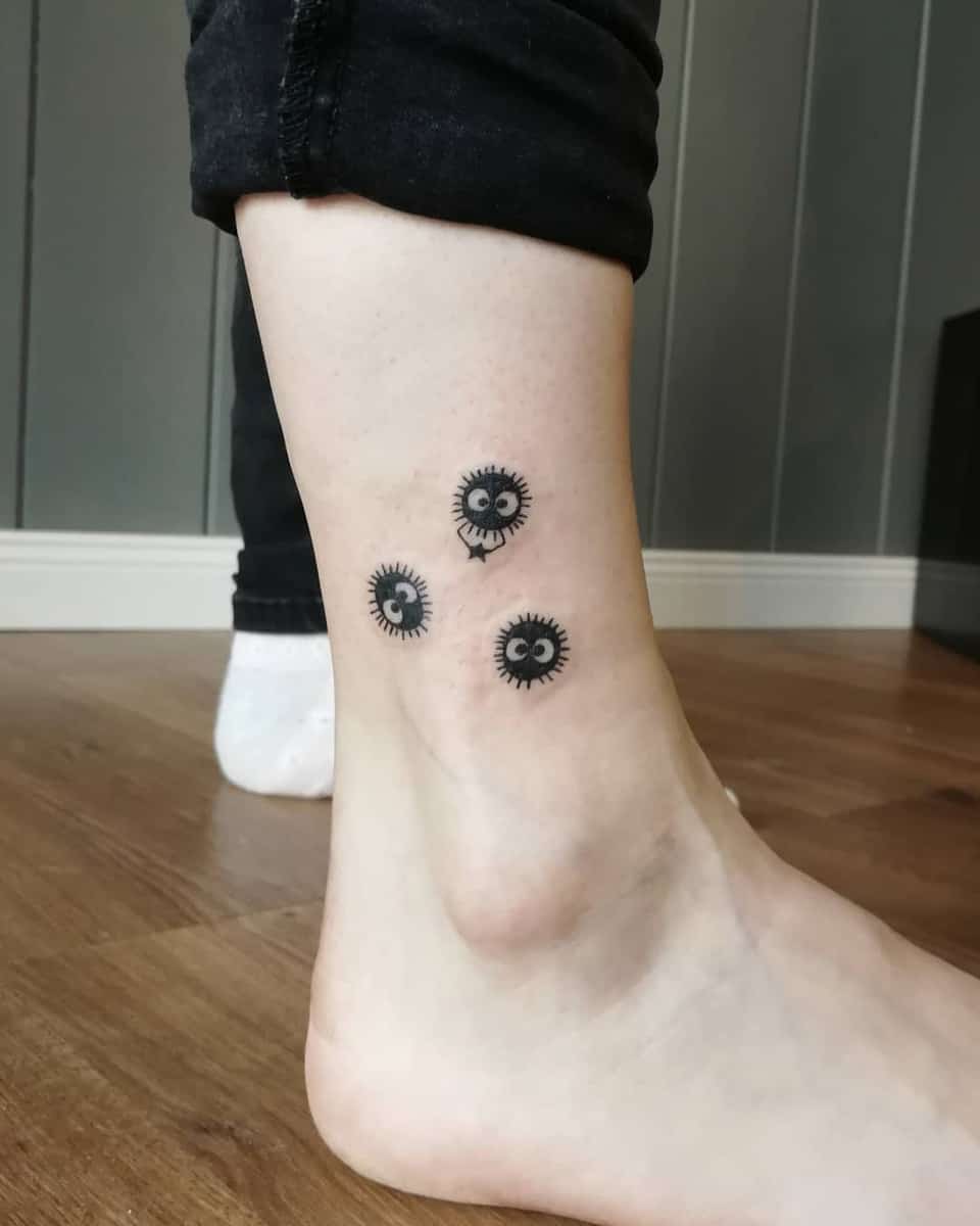Simple tattoo of three soot sprites from Studio Ghibli's Spirited Away on the ankle