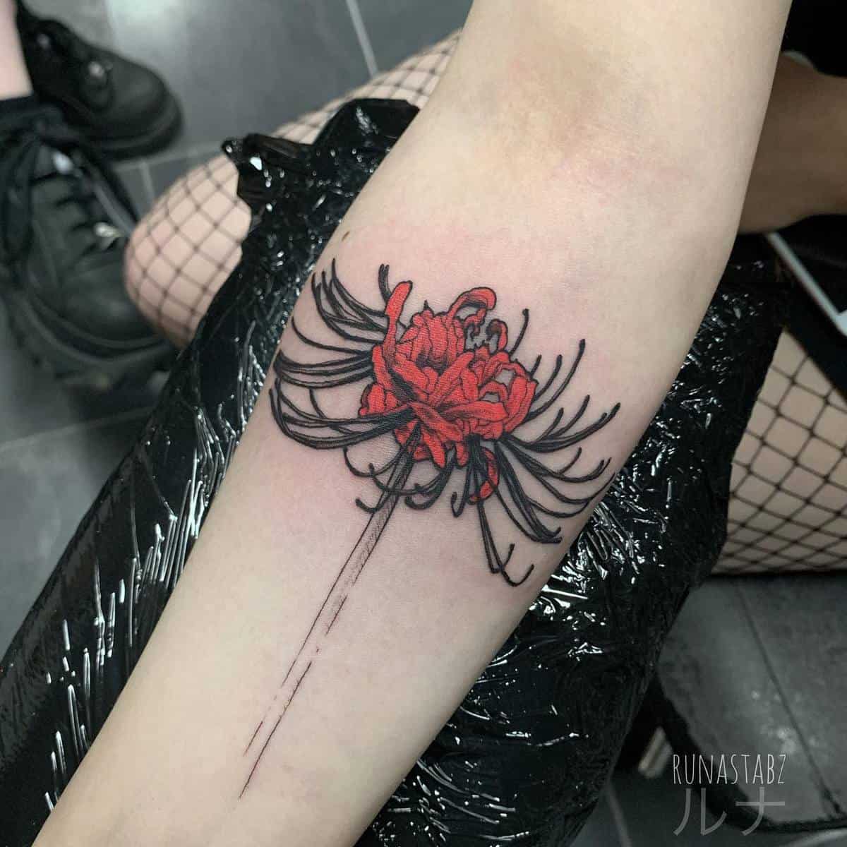 A tattoo of a red spider lily, symbolizing the beauty and ephemerality of life