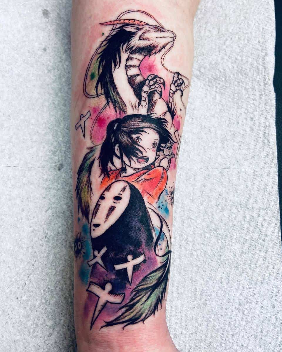 Colorful forearm tattoo featuring Chihiro, No-Face, Haku in dragon form, and soot sprites from Spirited Away