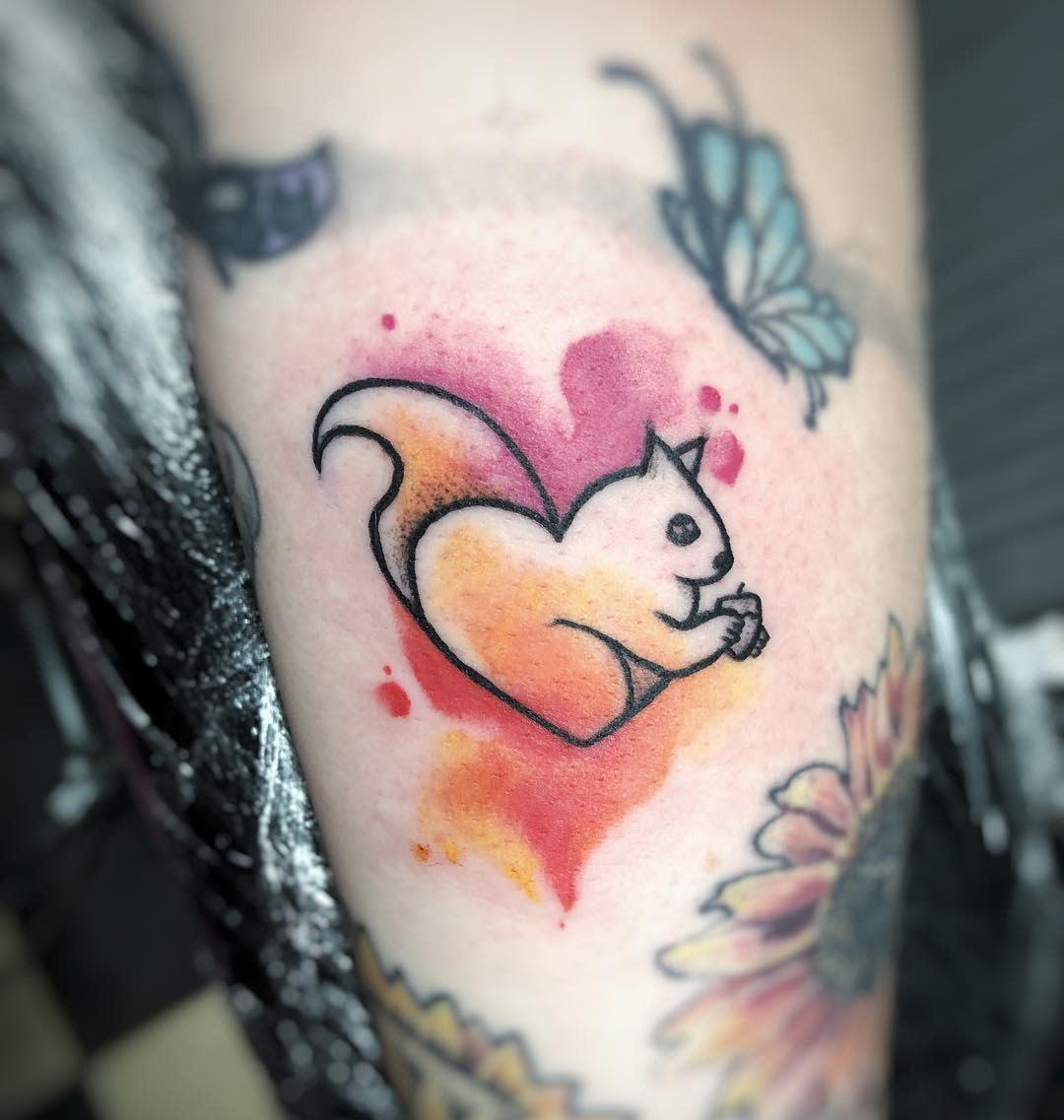 Colorful heart-shaped squirrel tattoo featuring sunflower and butterfly designs