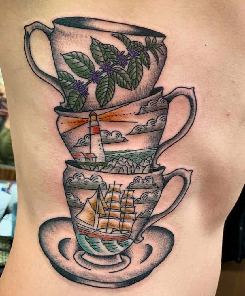 Colorful tattoo of three stacked teacups, each featuring a different scenic design—tea leaves, a lighthouse, and a sailing ship