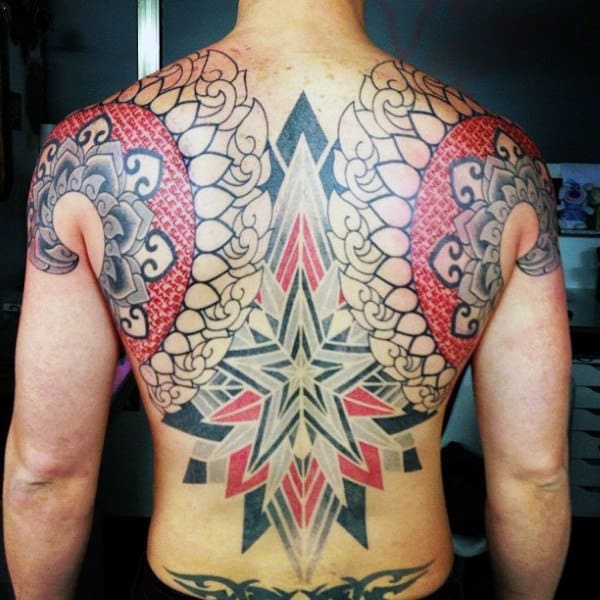 Person with intricate symmetrical back tattoos featuring geometric and floral designs