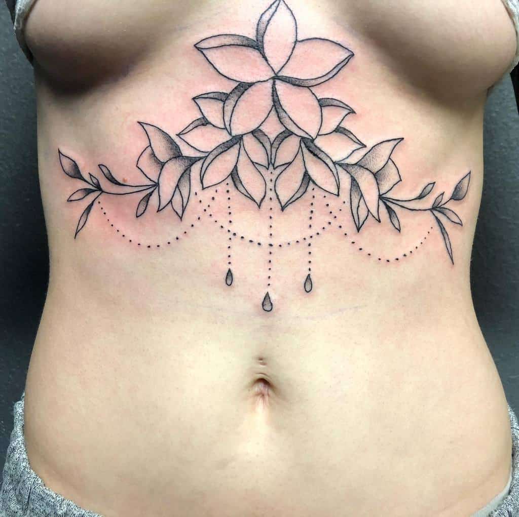 A tattoo featuring floral designs, chandelier-style beadwork and dangling dotted lines