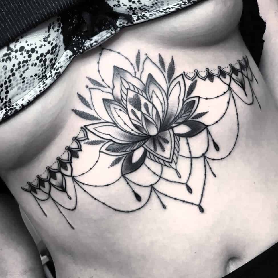 A detailed black and white lotus chandelier tattoo, featuring intricate lines and symmetrical patterns