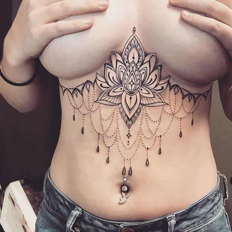 Chandelier tattoo with a large lotus flower, intricate dangling dot work with dangling bead accents