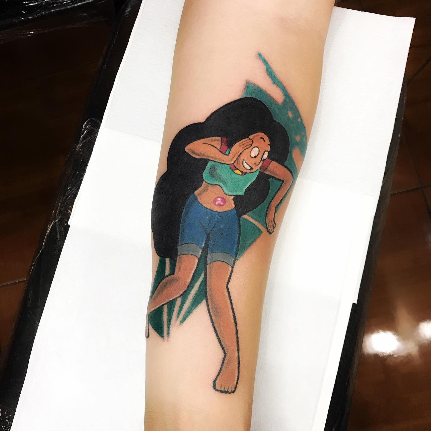 Colorful tattoo of Connie Maheswaran from Steven Universe in a dynamic pose, featuring her long flowing hair and a determined expression, on the forearm